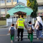 Bhabinkamtibmas Desa Apitaik Gelar Strong Point Pagi, Pastikan Pelajar Aman Menyeberang Jalan